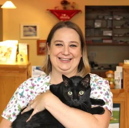 Veterinary Technician Holding a Black Cat